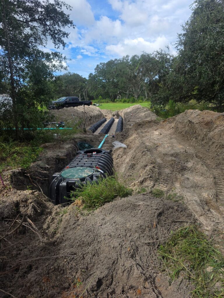 Septic tank and drain field chambers set in an open trench on a rural lot