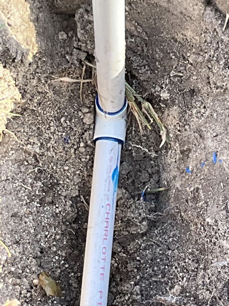 PVC water line joined with a coupling in an open trench